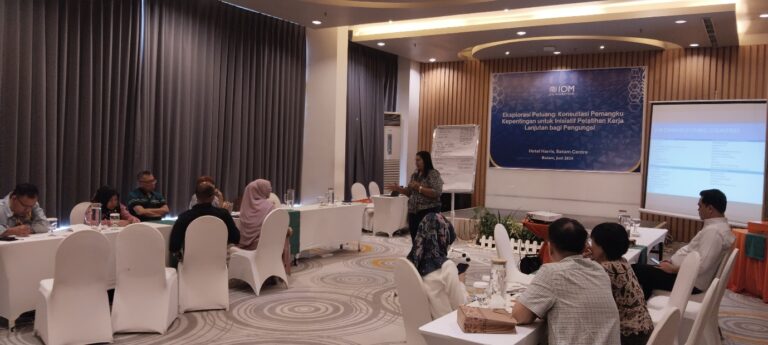 A group of people in a room Description automatically generated