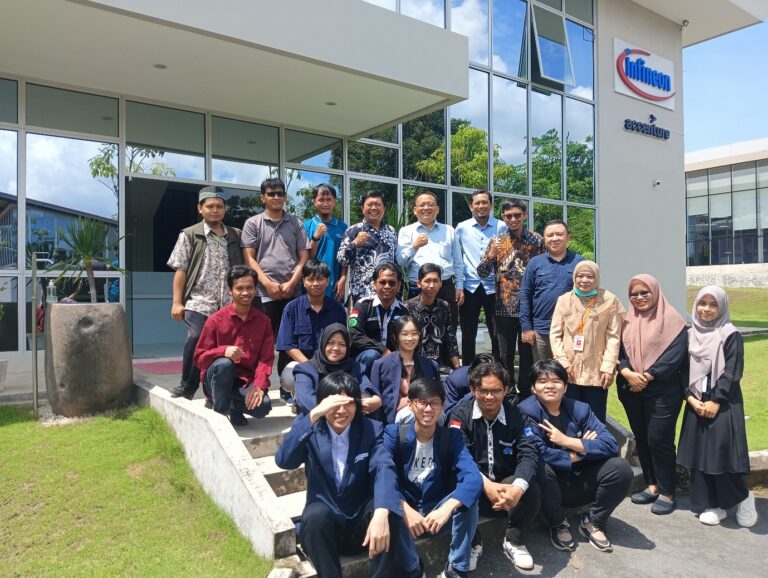 A group of people posing for a photo outside of a building Description automatically generated
