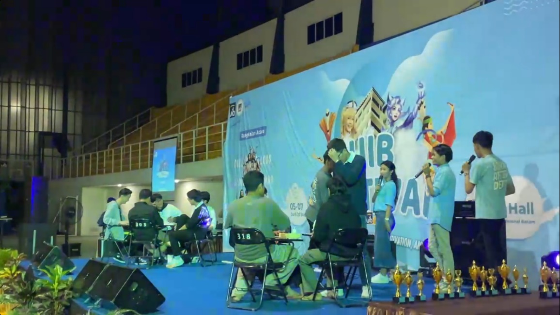 A group of people sitting on a stage
Description automatically generated