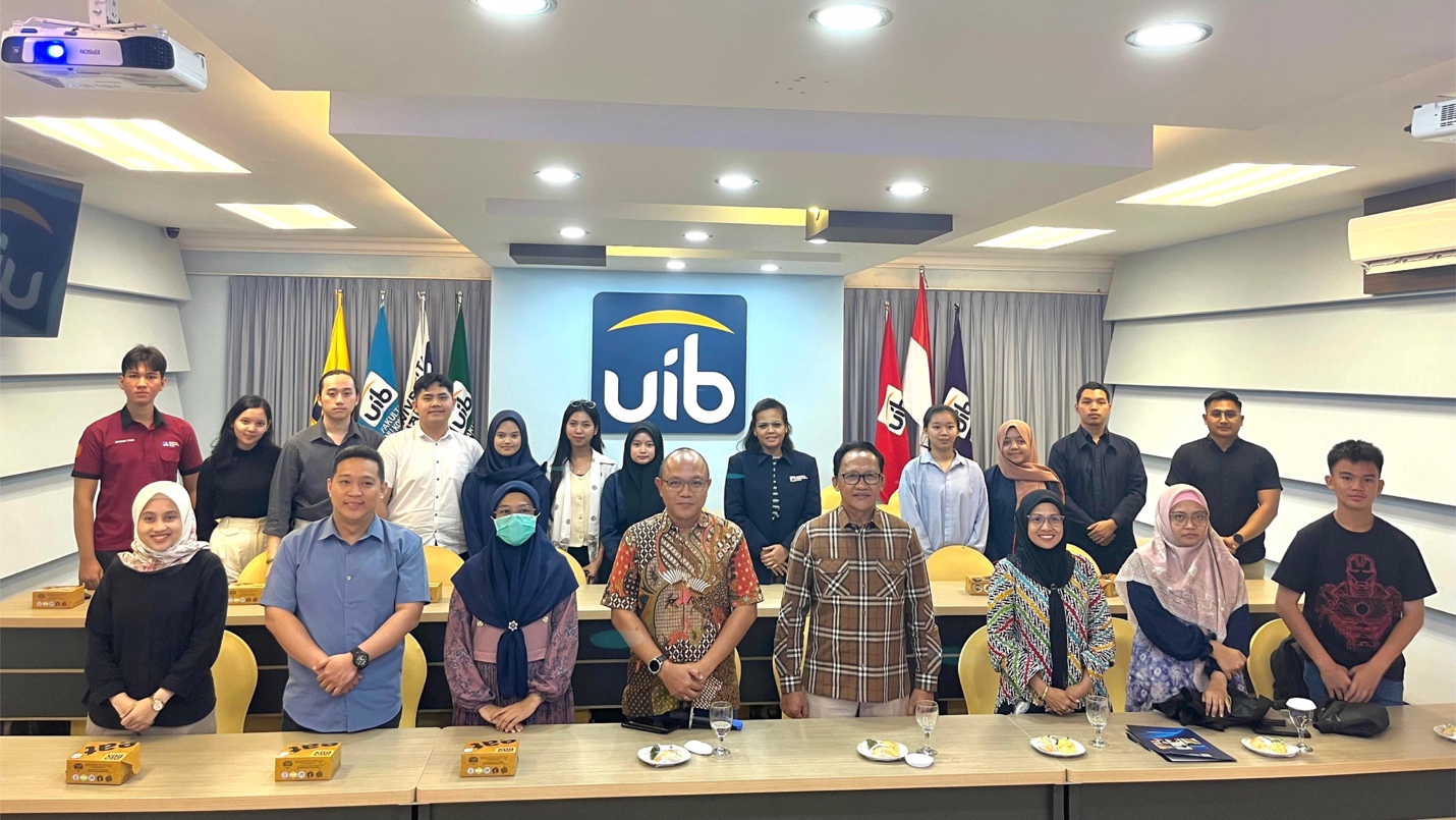 A group of people standing in a room

Description automatically generated