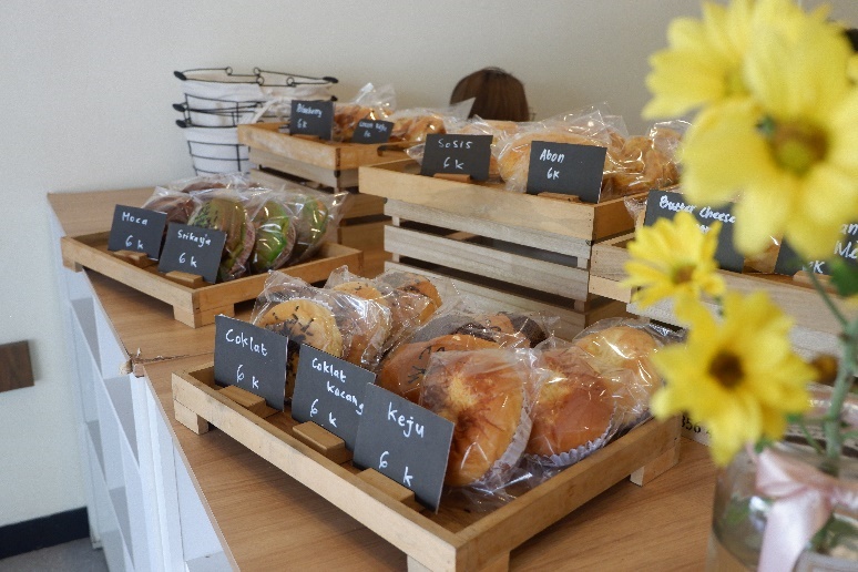 A variety of pastries in wooden boxes

Description automatically generated