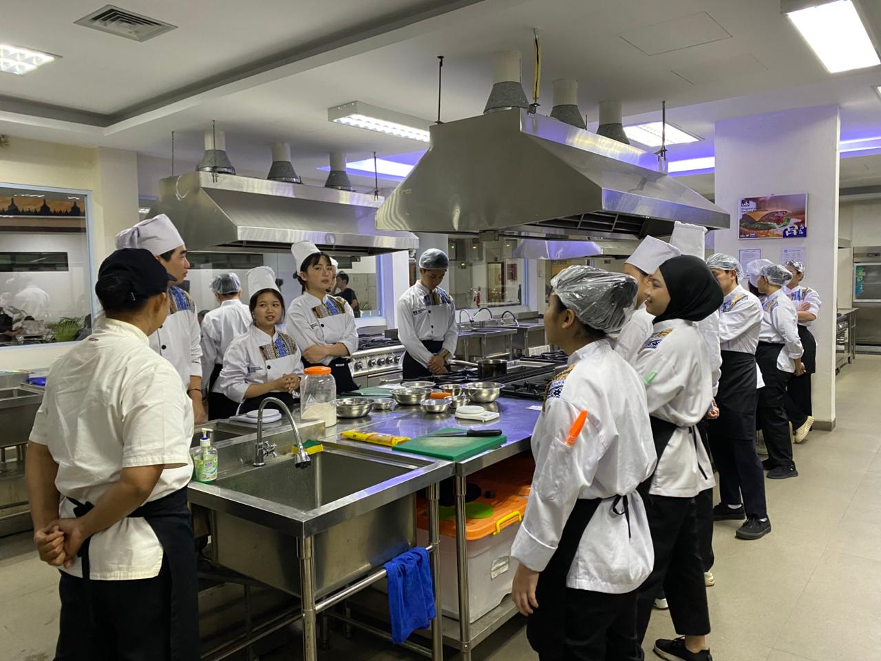 A group of people in a kitchen

Description automatically generated