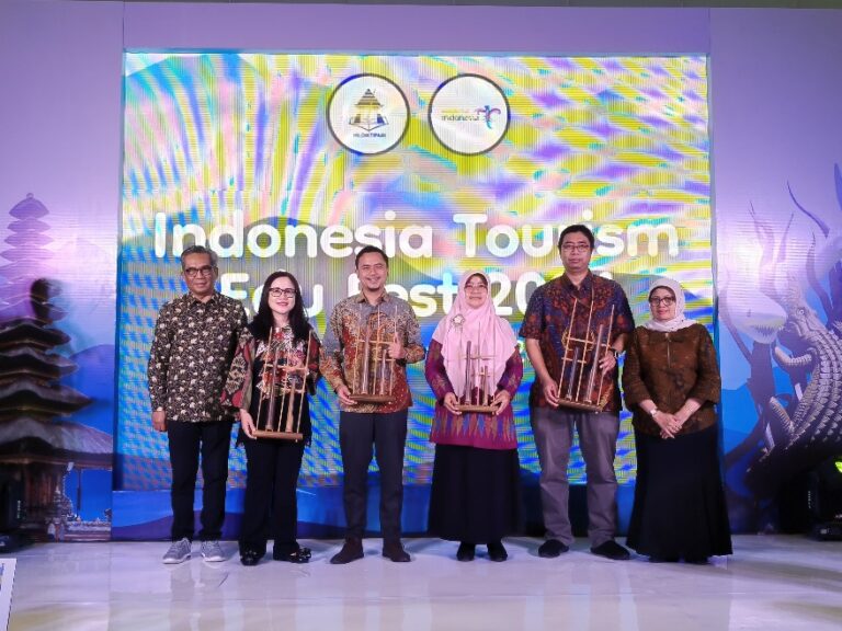 A group of people standing on a stage Description automatically generated