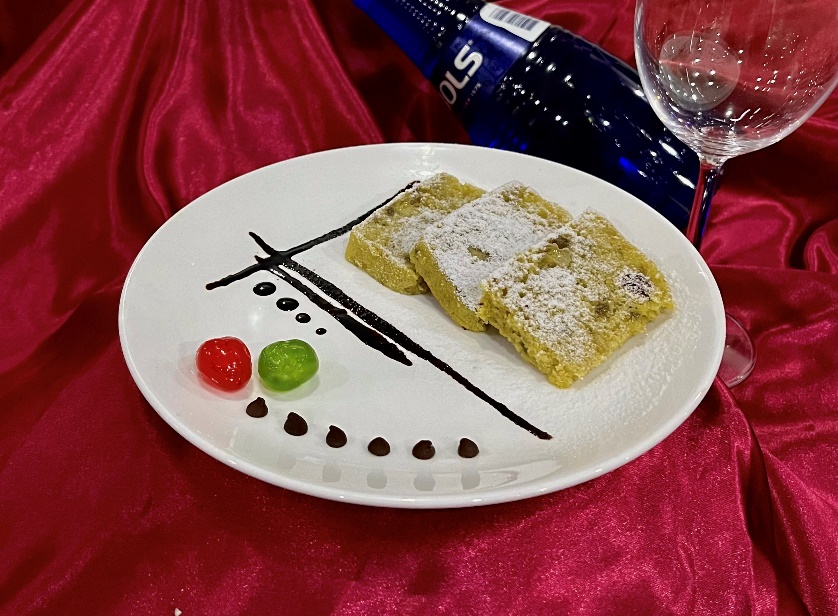 A plate of food and a glass of wine

Description automatically generated