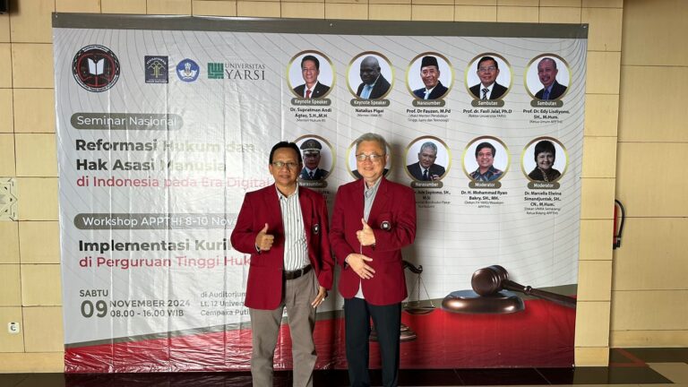 Two men standing in front of a banner Description automatically generated