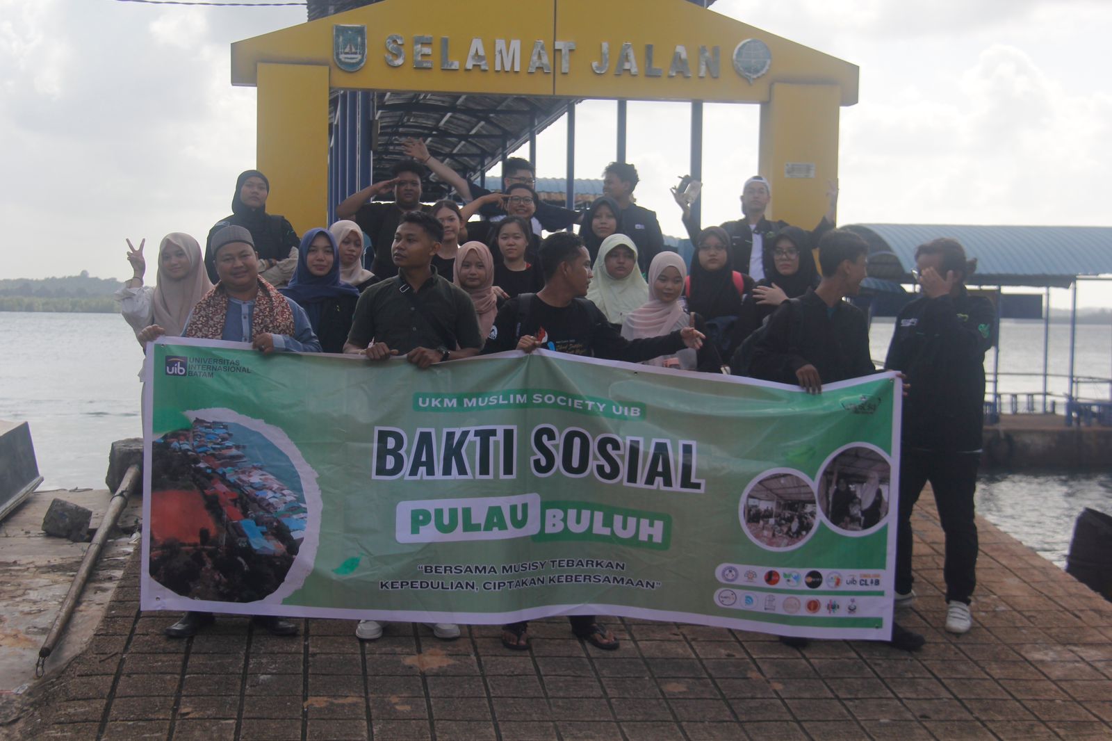 A group of people holding a banner

Description automatically generated