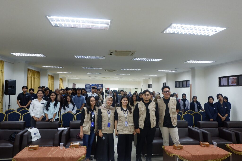 A group of people standing in a room Description automatically generated