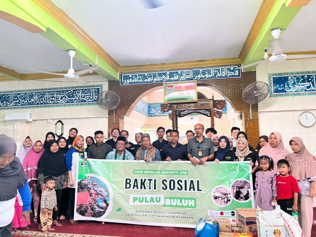 A group of people standing in a room Description automatically generated