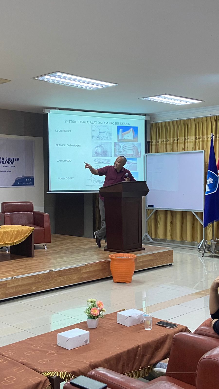 A person standing at a podium

Description automatically generated