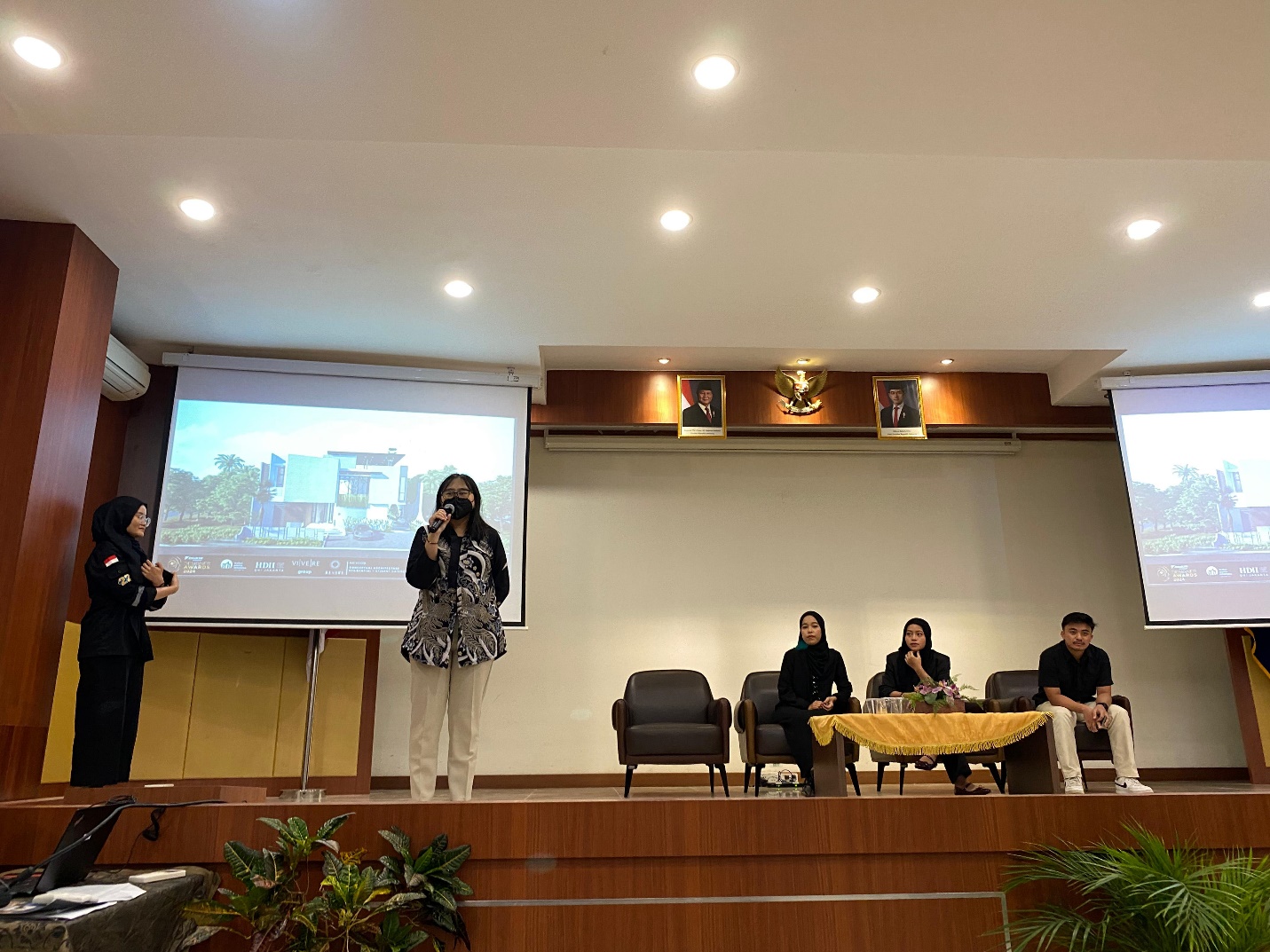 A person on a stage with a projector screen

AI-generated content may be incorrect.