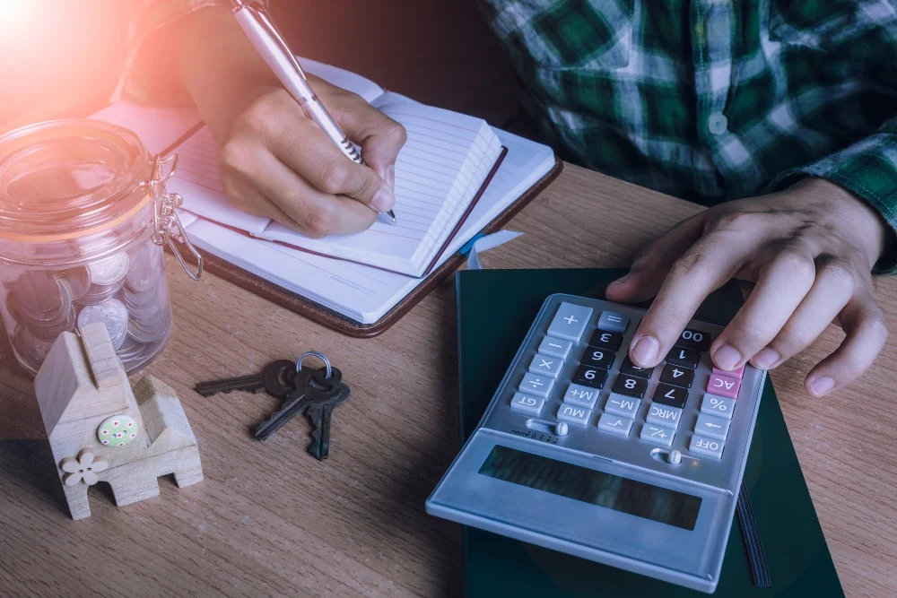 A person using a calculator AI-generated content may be incorrect.