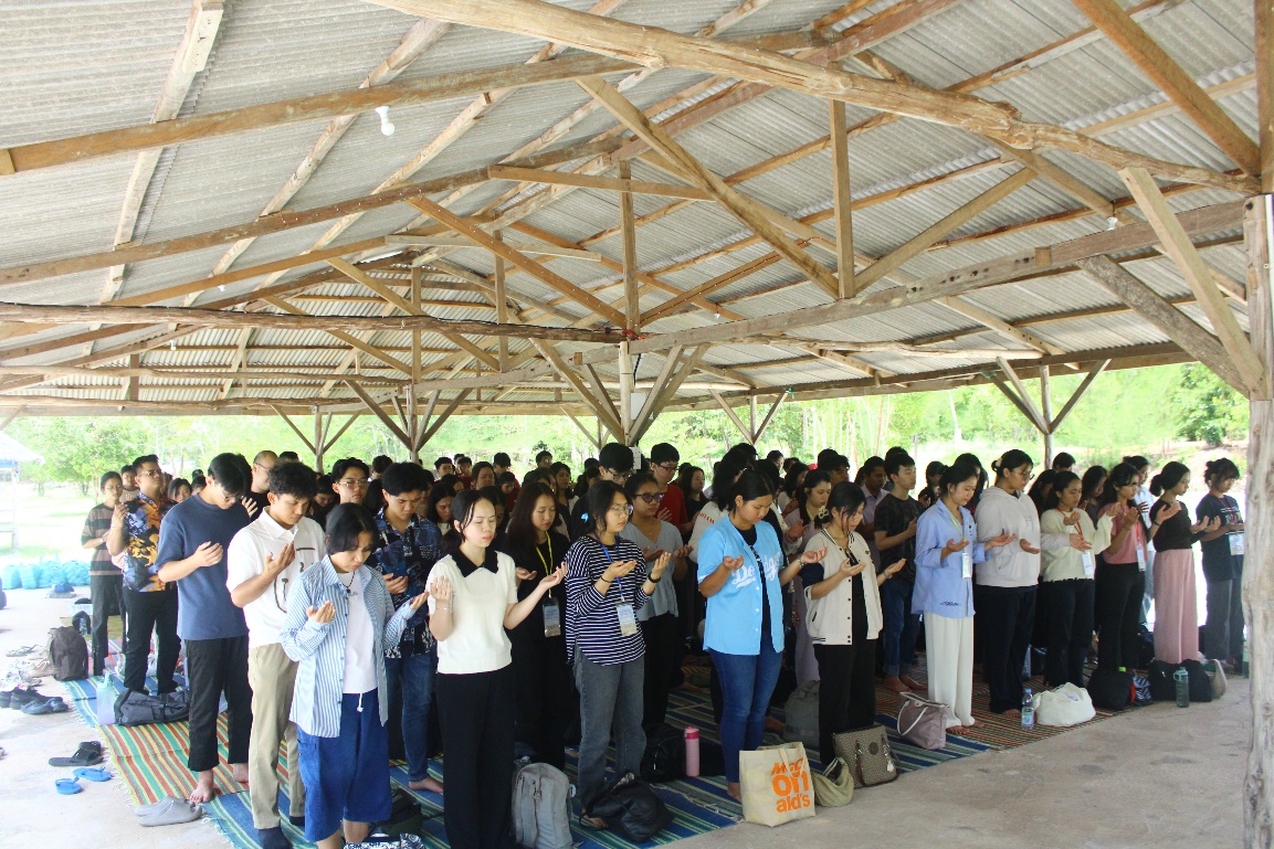 A group of people praying under a roof AI-generated content may be incorrect.