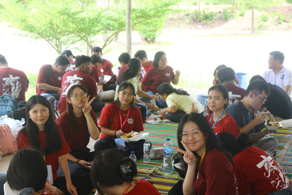 A group of people sitting on a table AI-generated content may be incorrect.