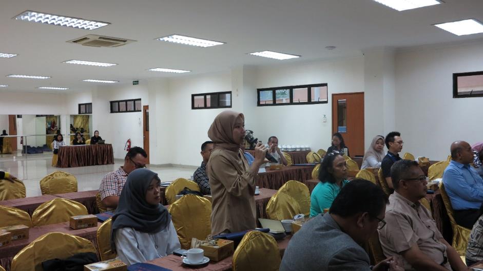 A person speaking into a microphone in a room with people sitting at tables

AI-generated content may be incorrect.