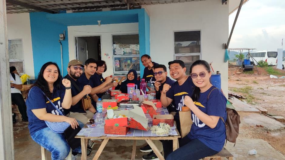 A group of people sitting at a table AI-generated content may be incorrect.