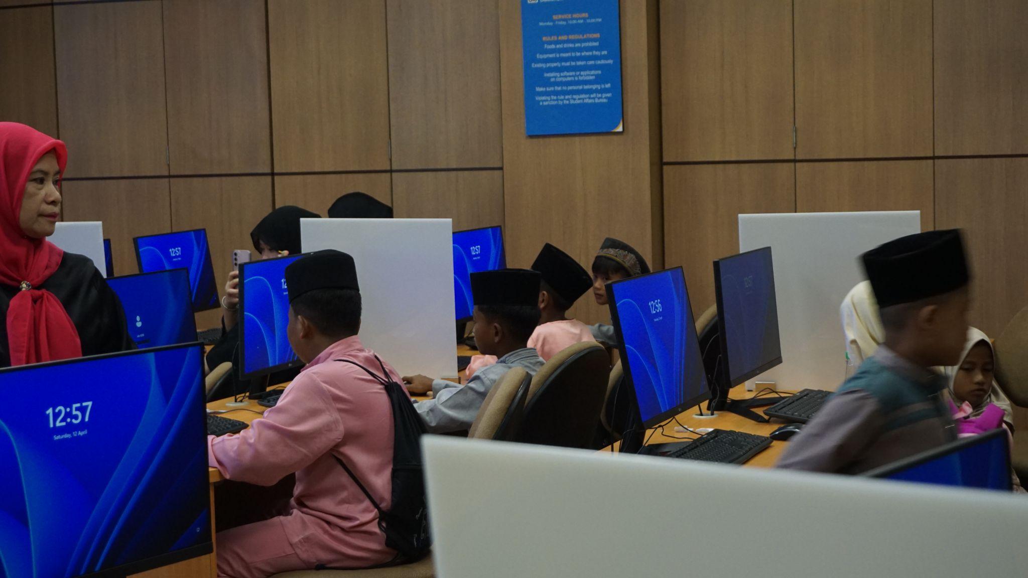 A group of people sitting at computers AI-generated content may be incorrect.