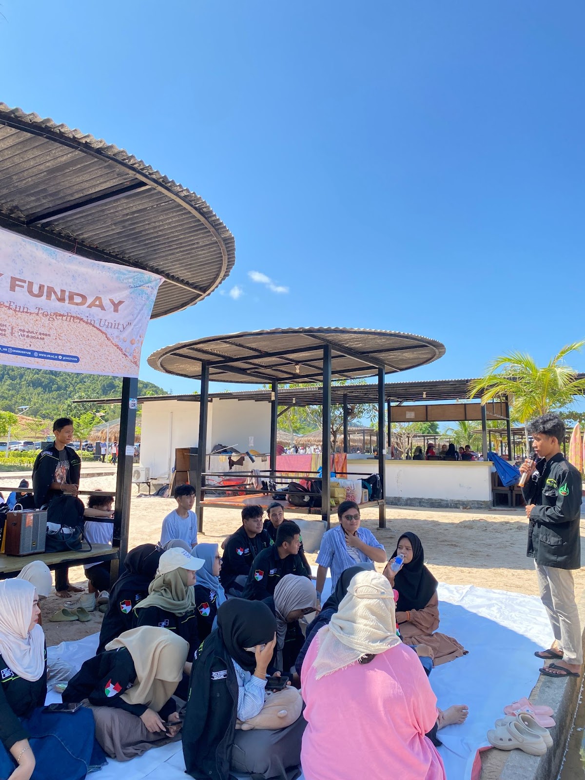 A group of people sitting on a white surface

AI-generated content may be incorrect.