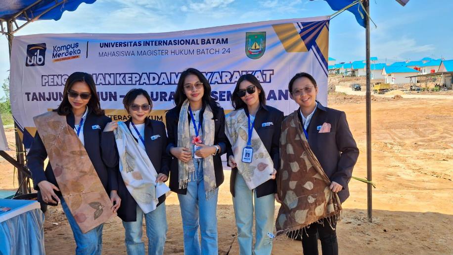A group of women standing in front of a banner Description automatically generated