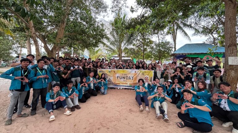 A group of people sitting in the sand Description automatically generated