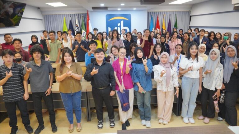 A group of people standing in a room Description automatically generated