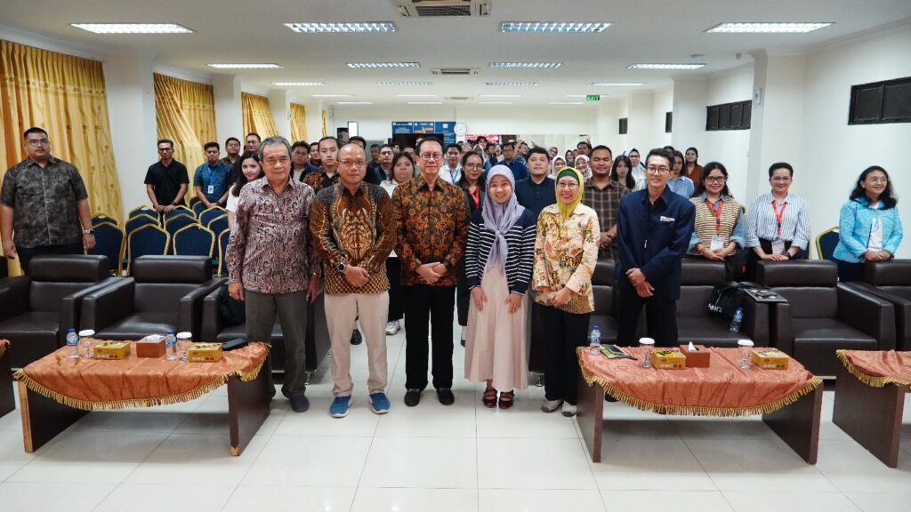 A group of people standing in a room Description automatically generated