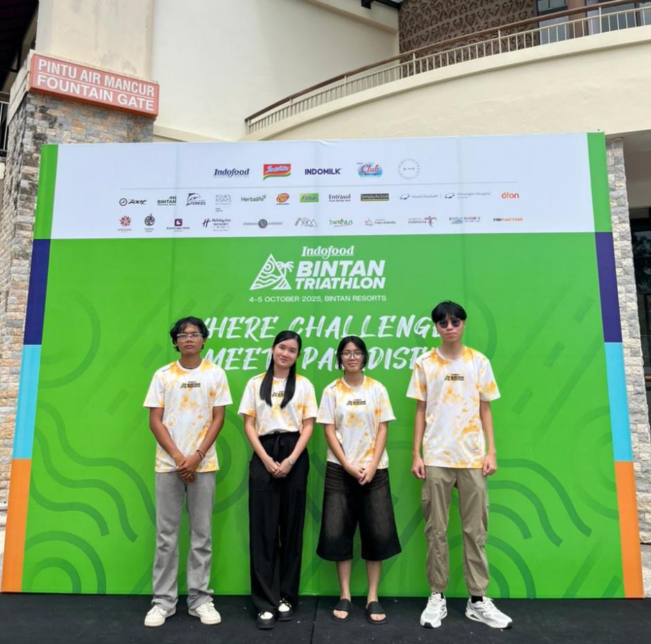 A group of people standing in front of a sign

AI-generated content may be incorrect.