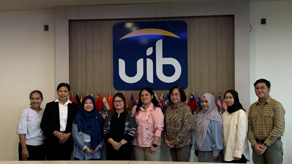 A group of people standing in front of a sign

AI-generated content may be incorrect.