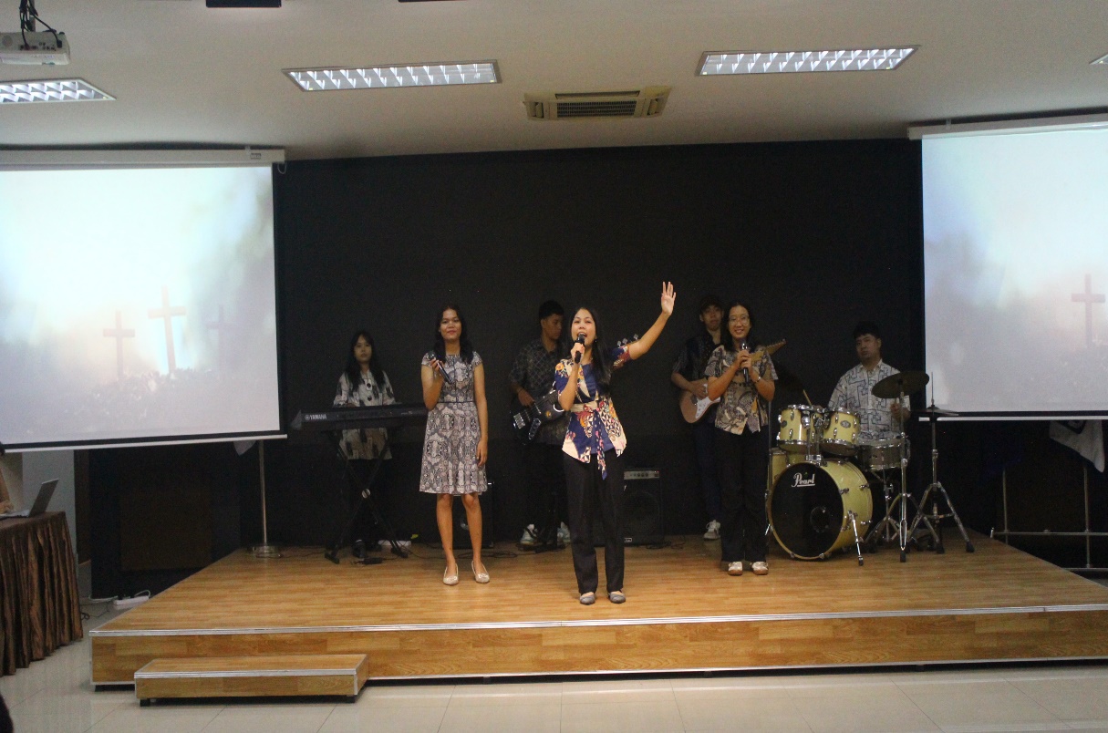 A group of people performing on stage Description automatically generated