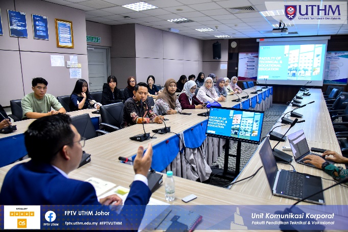 A group of people sitting at a table Description automatically generated