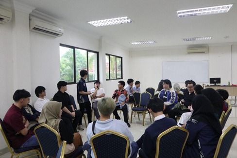 A group of people sitting in a room
AI-generated content may be incorrect.