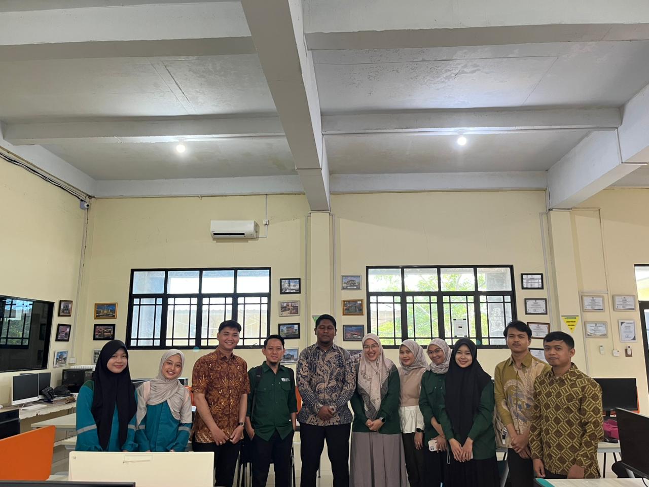 A group of people standing in a room

Description automatically generated