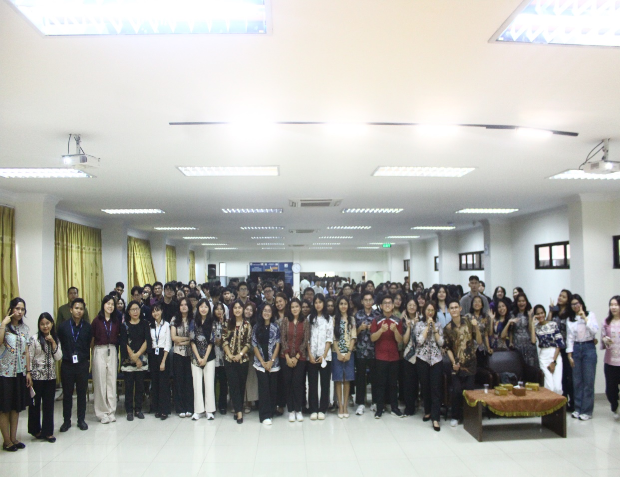 A group of people standing in a room Description automatically generated