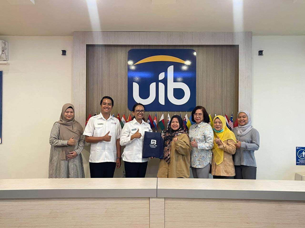 A group of people standing in front of a sign
AI-generated content may be incorrect.