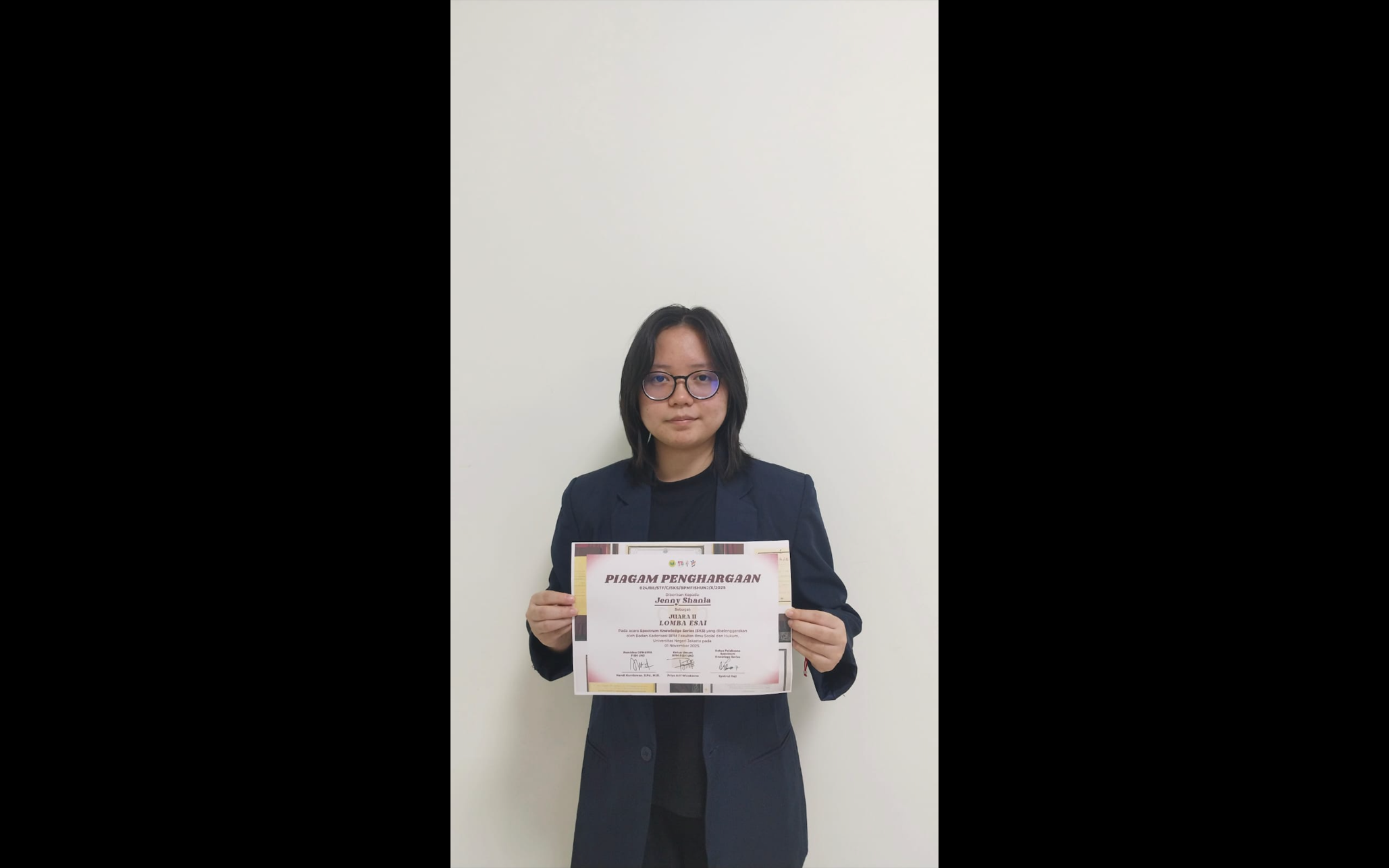 A person holding a paper
Description automatically generated