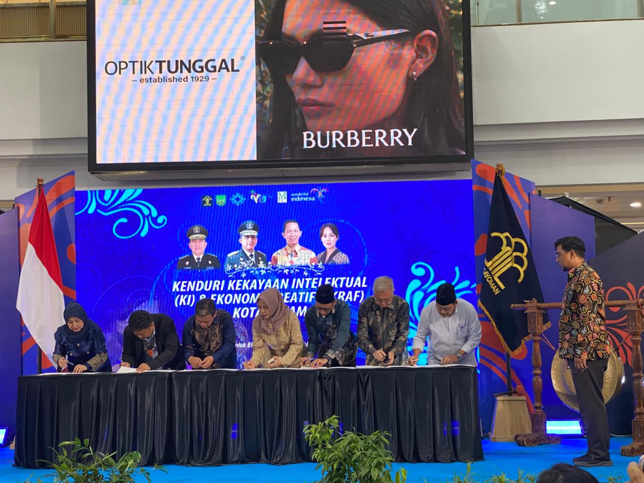 A group of people sitting on a stage
Description automatically generated