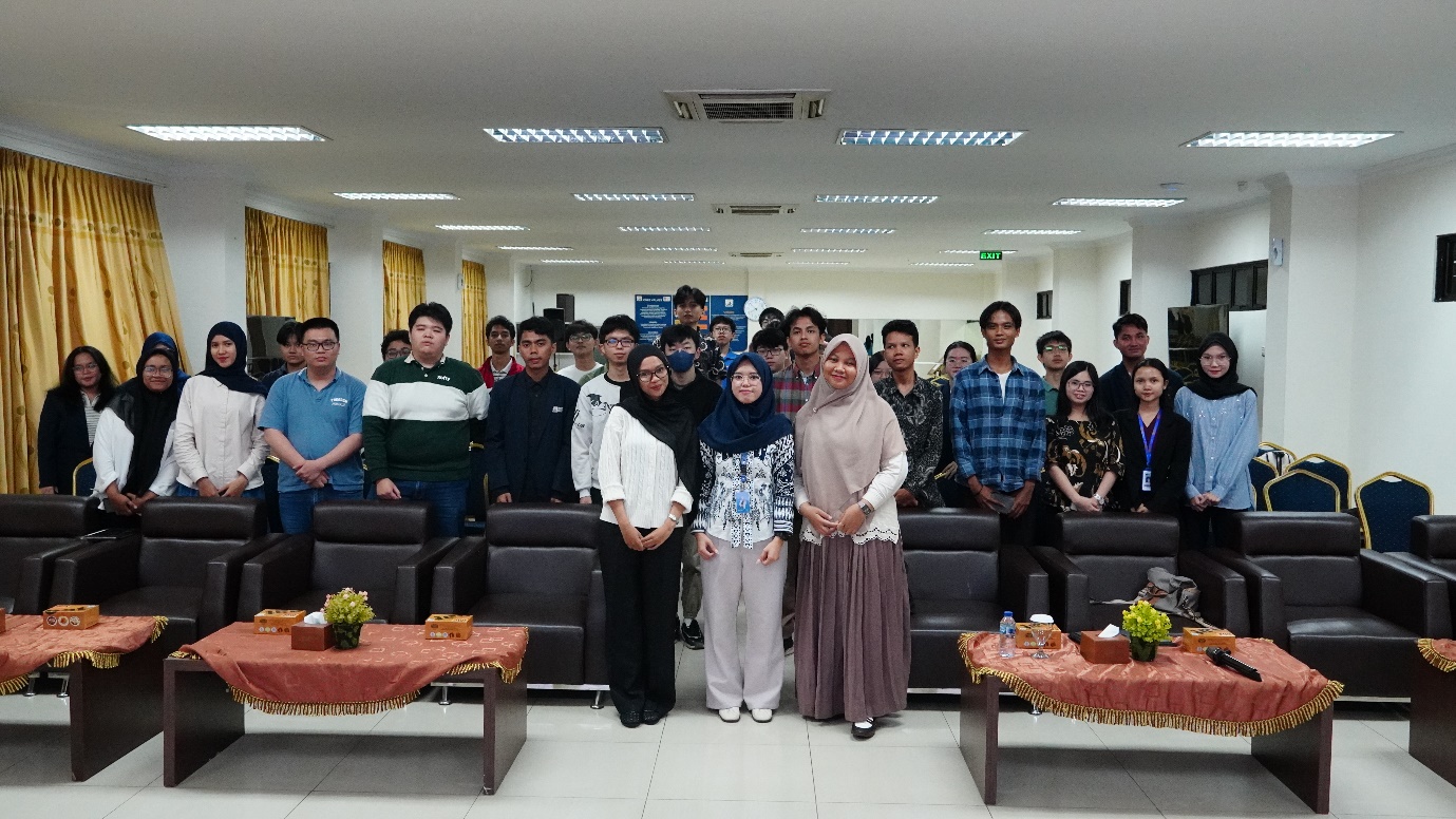 A group of people standing in a room Description automatically generated