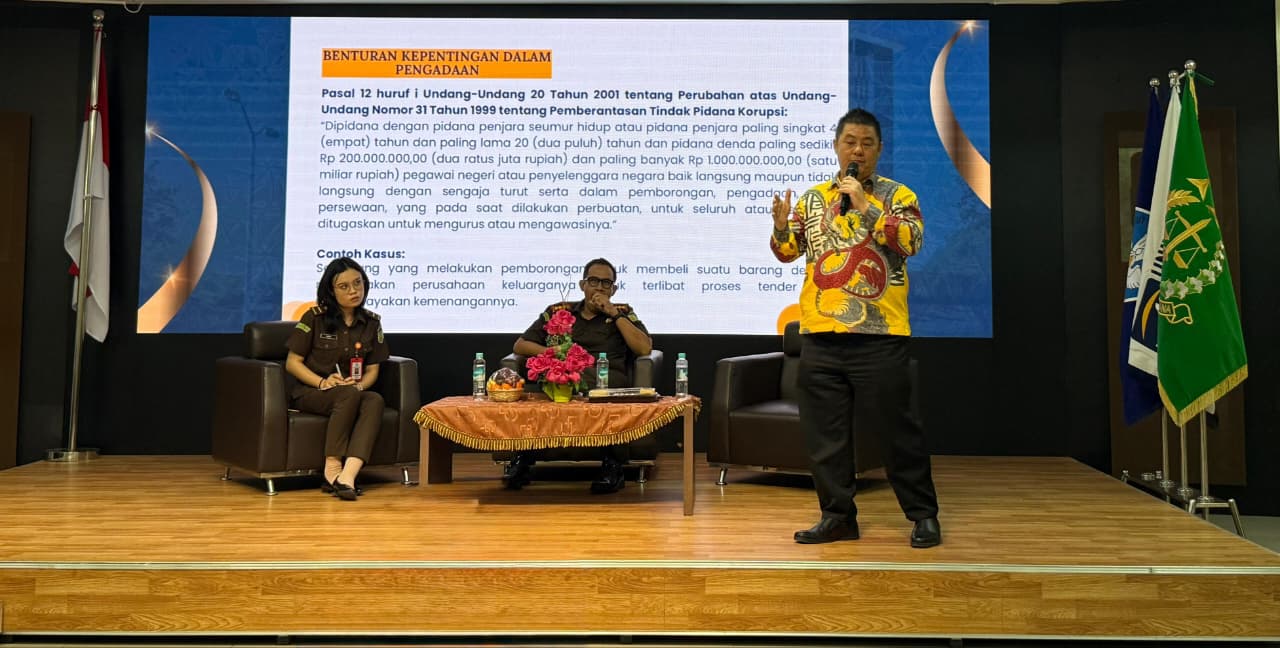 A person speaking into microphone on stage Description automatically generated