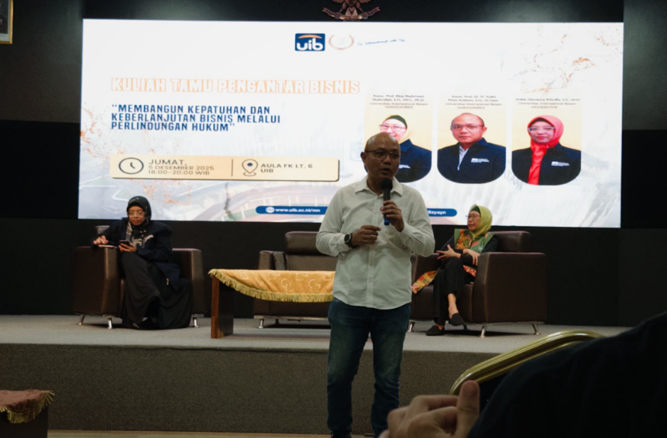 A person standing in front of a stage with a microphone

AI-generated content may be incorrect.