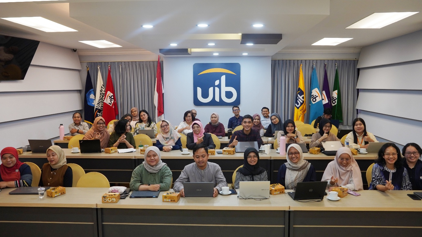 A group of people sitting in a room with flags

Description automatically generated