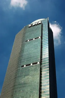 A tall building with a blue sky AI-generated content may be incorrect.