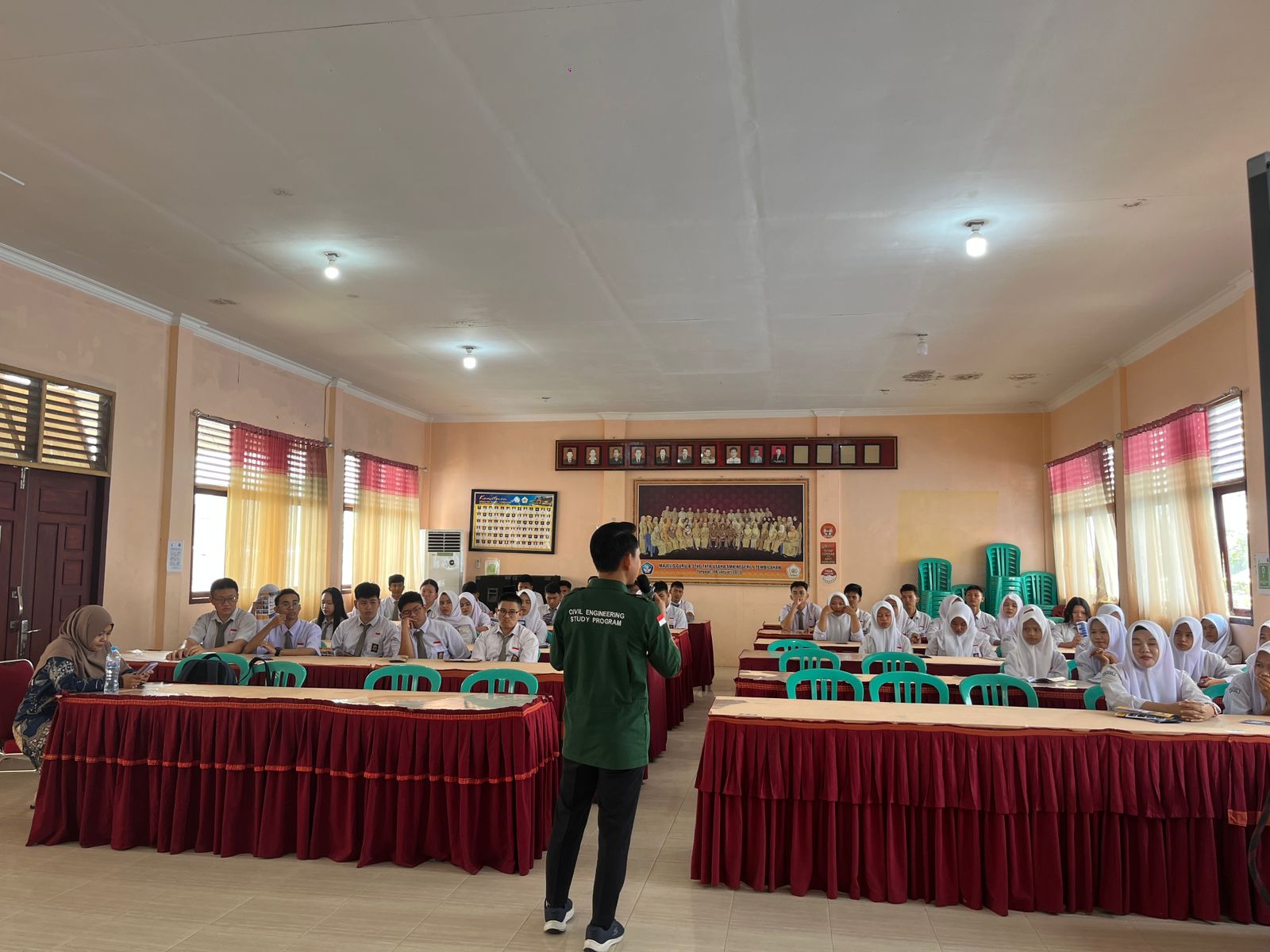 A group of people in a room Description automatically generated