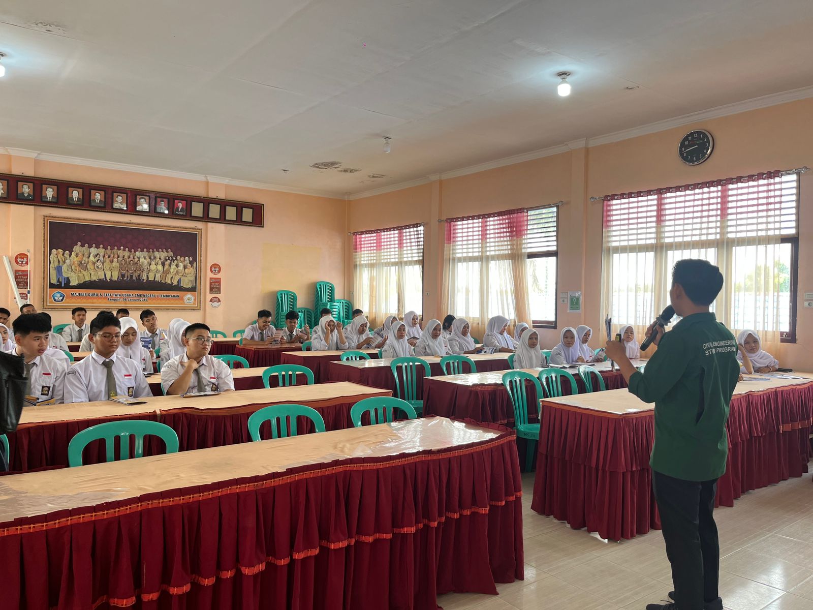 A group of people in a room Description automatically generated