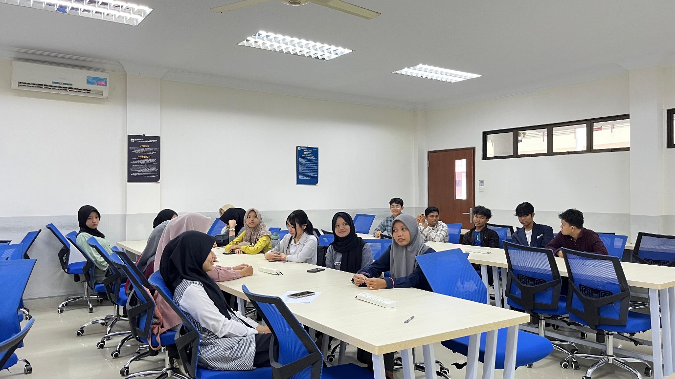 A group of people sitting at a table Description automatically generated