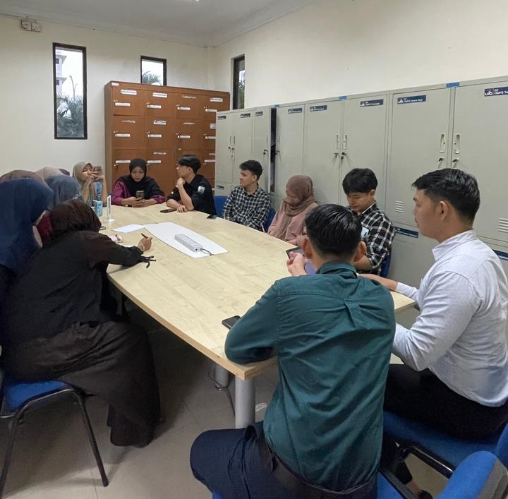 A group of people sitting around a table
Description automatically generated