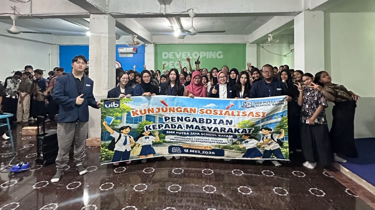 A group of people holding a banner

Description automatically generated